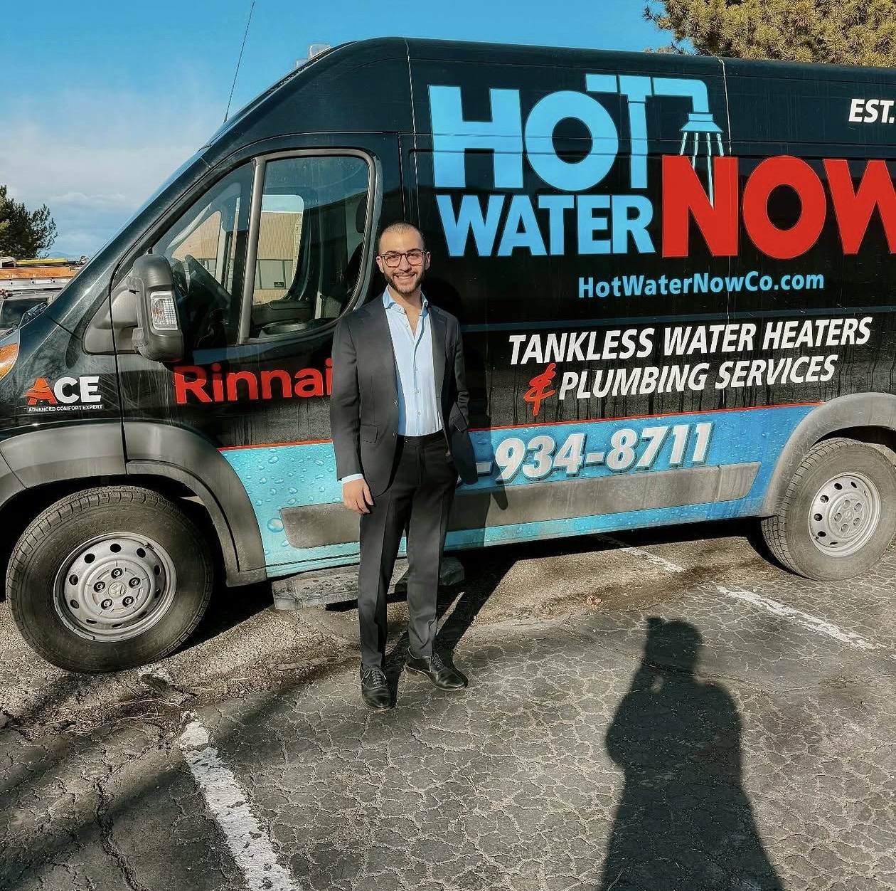 Elias Youssef beside a Hot Water Now! service van.